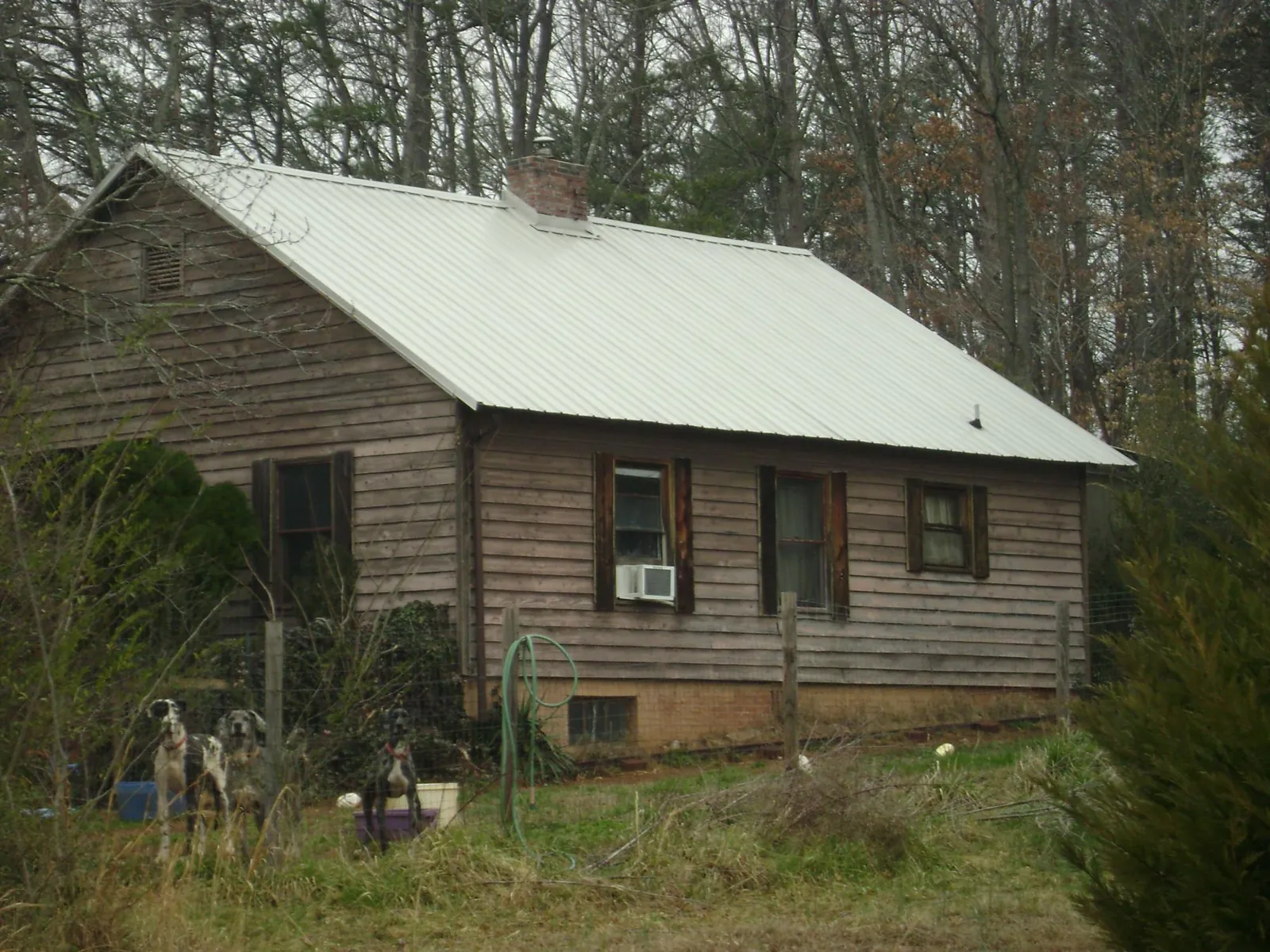 White metal roof on an old wood sided farmhouse, from a Asphalt Shingle Roof Repair job in Van